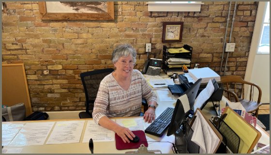 History Center volunteer sitting at welcome desk