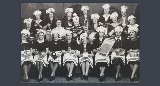 Women in a band holding instruments made from kitchen items