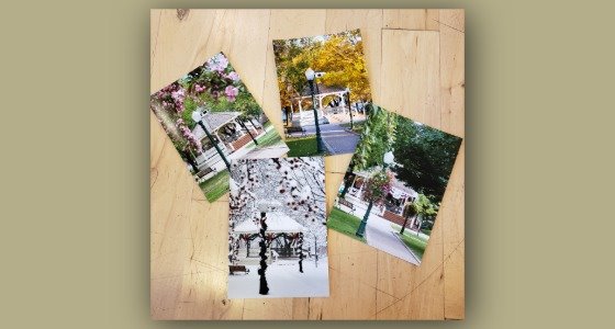4 postcards with Gazebo in different seasons laying on a table