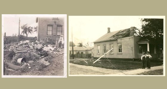 Debris all over a yard, two boys stand in front of a house with half the roof collapsed