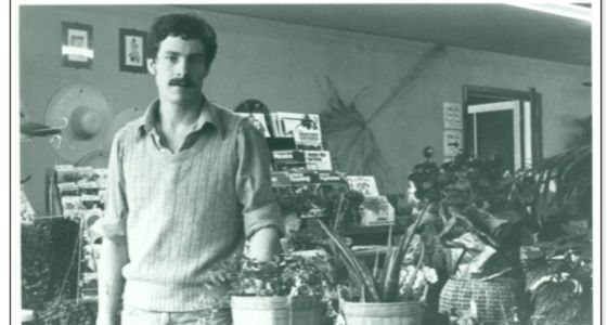 Tom Hayden, owner of Chaska Farm and Garden, standing next to plants