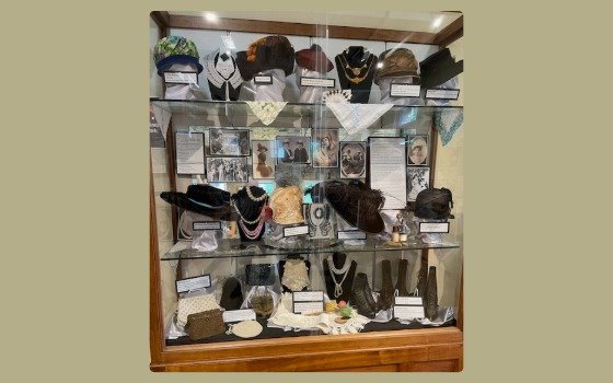 Hats and accoutrements in a display case