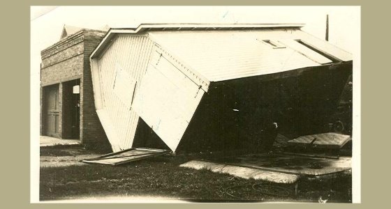 Wooden garage leaning on its side
