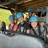 three girls smiling on a field trip