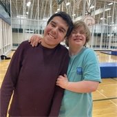 two boys smiling in a gymnasium