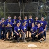 adult kickball team smiling on the field