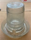 An old glass chicken waterer
