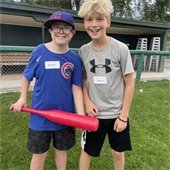 two boys smiling at an adaptive baseball game