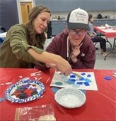 picture of two people participating in an art class